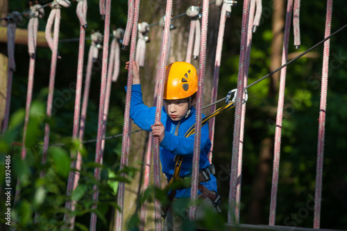 boy climbing in adventure park, rope park