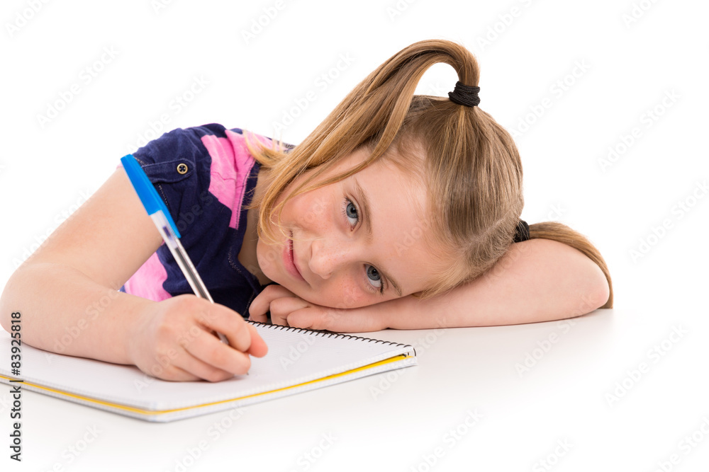 Blond kid girl student with spiral notebook in desk Blond kid girl student with spiral notebook in desk