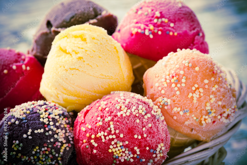 Ice cream scoops on wooden table.