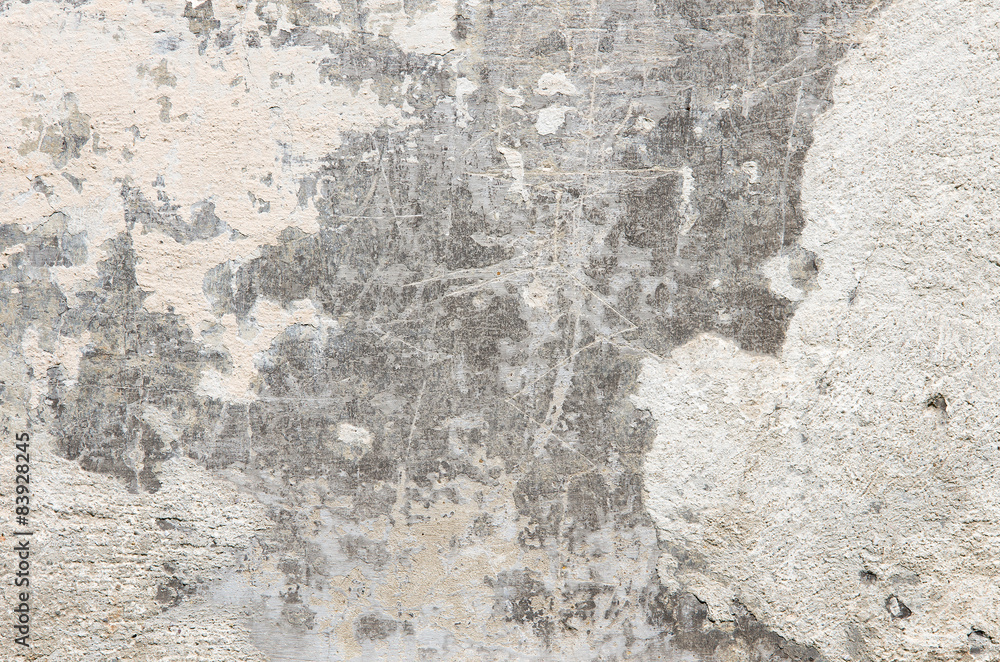 Gray cement wall with traces of crumbling plaster. Gray cement wall with traces of crumbling plaster.