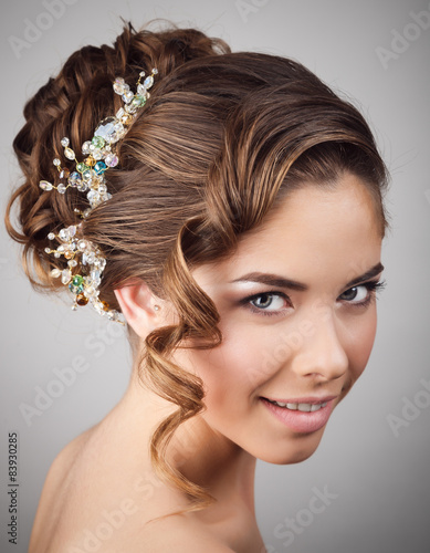 Studio portrait of cheerful bride with perfect make-up and hairs