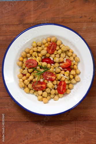 salad with chickpea and tomato on white plate