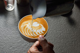 Making of cafe latte art, wave heart shape
