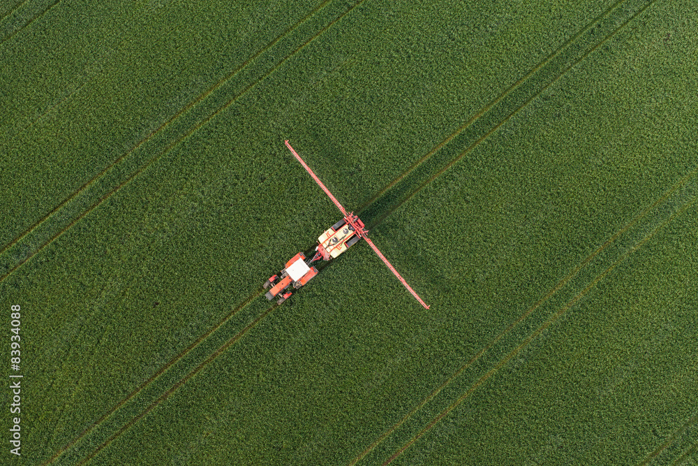Fototapeta premium aerial view of harvest fields with tractor