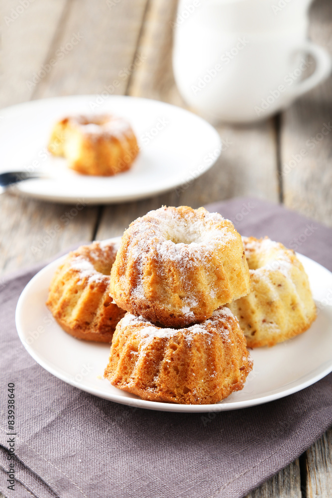 Bundt cakes on plate on grey wooden background Bundt cakes on plate on grey wooden background