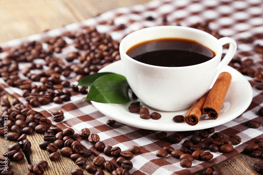 Cup of coffee with cinnamon and leaves Cup of coffee with cinnamon and leaves