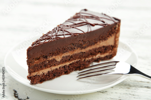 Dark chocolate cake on white wooden background