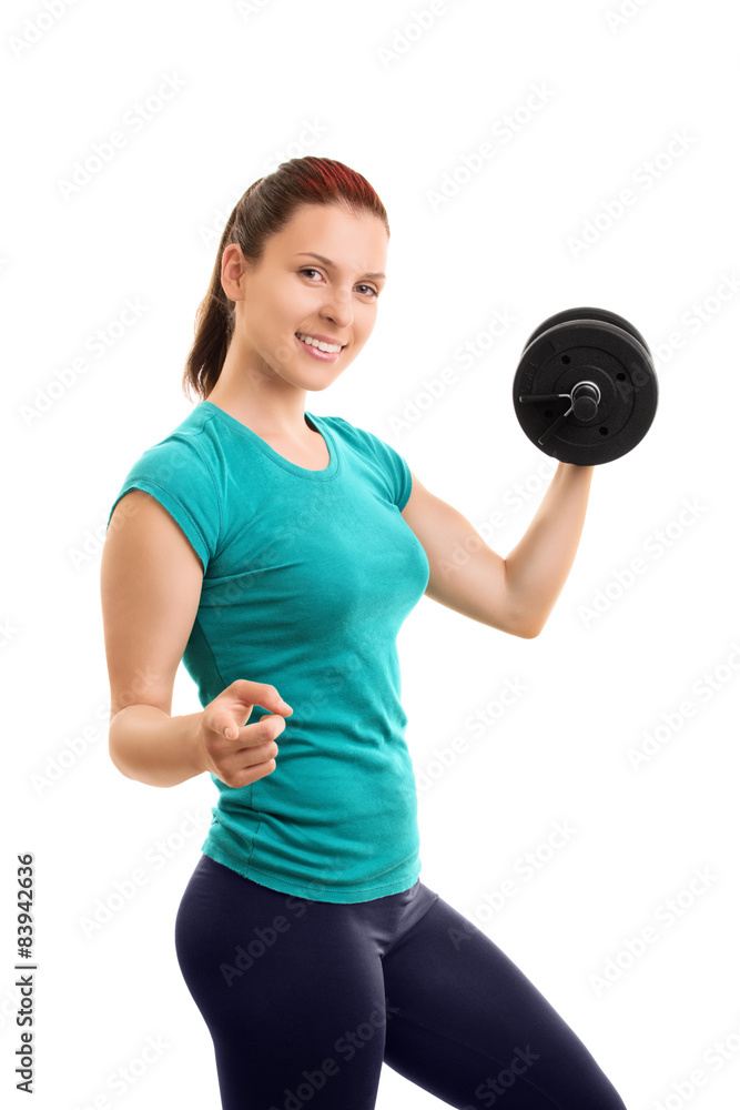 Young girl lifting weights and pointing towards you Young girl lifting weights and pointing towards you