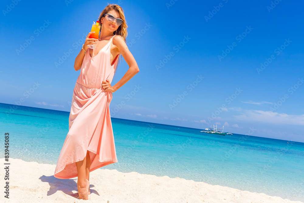young happy beautiful woman with bright tropical cocktail on blu young happy beautiful woman with bright tropical cocktail on blu