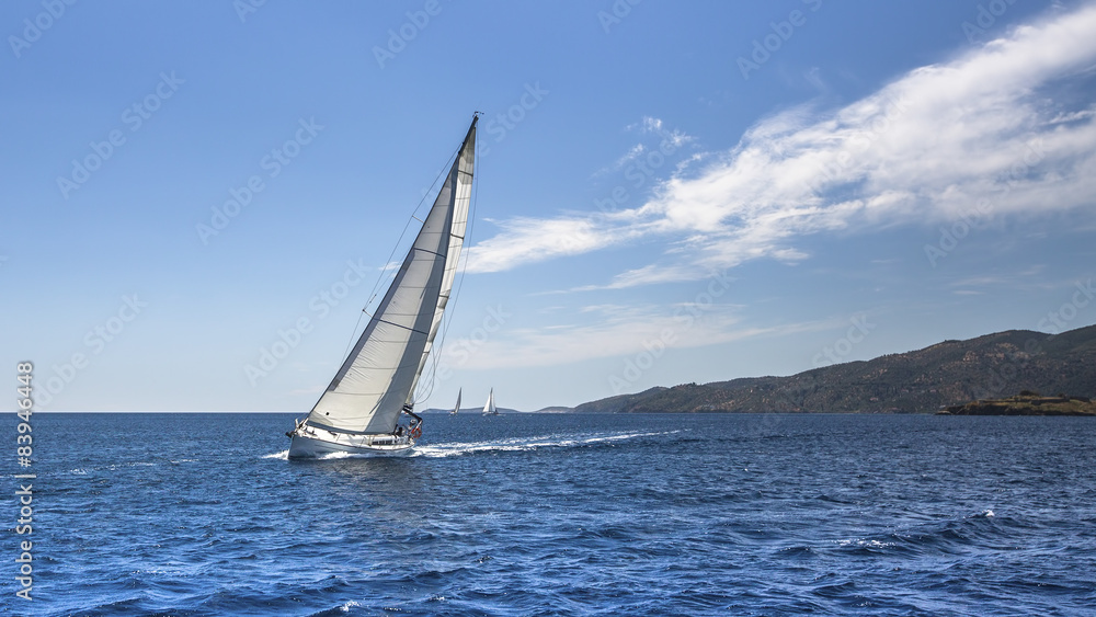 Sailing. Yacht sails with beautiful cloudless sky.