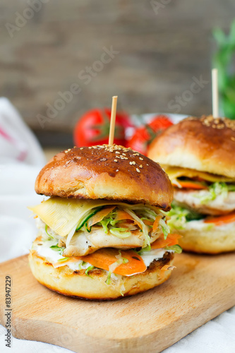 burgers with chicken and stuffed juicy with cucumber, carrots a