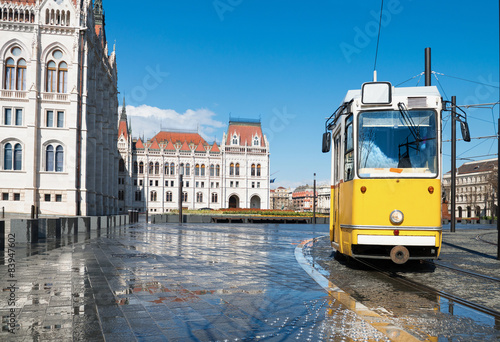 Historical tram passing by Parliament in Budapest, Hungary