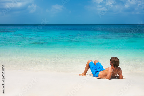 Young man relaxing on the beach