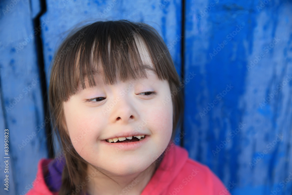 Young girl smiling on background of the blue wall. Young girl smiling on background of the blue wall.