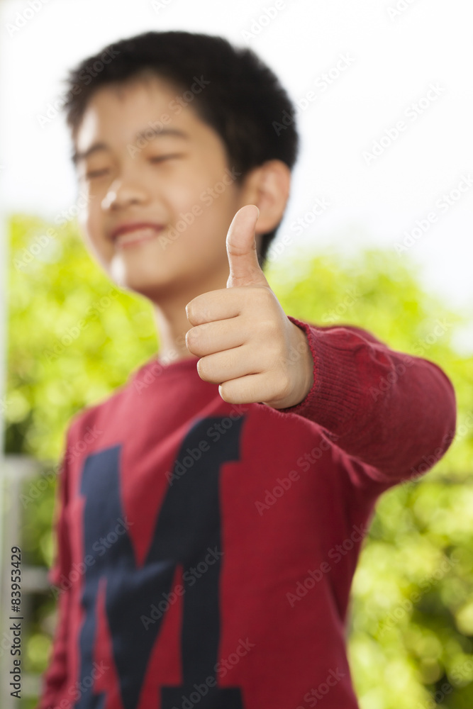 an Asian young boy pose showing expression smiling funny an Asian young boy pose showing expression smiling funny