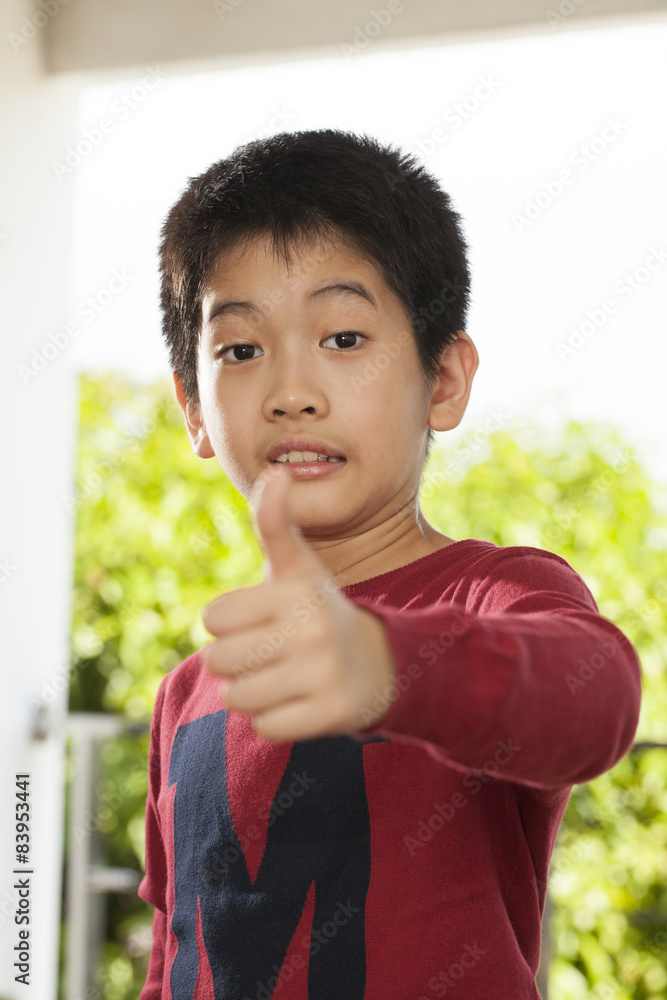 an Asian young boy pose showing expression smiling funny an Asian young boy pose showing expression smiling funny