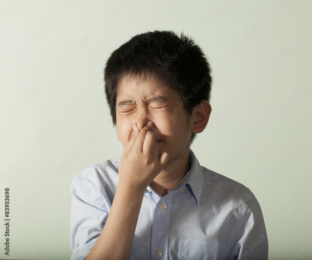 an Asian young boy pose showing expression smiling funny an Asian young boy pose showing expression smiling funny