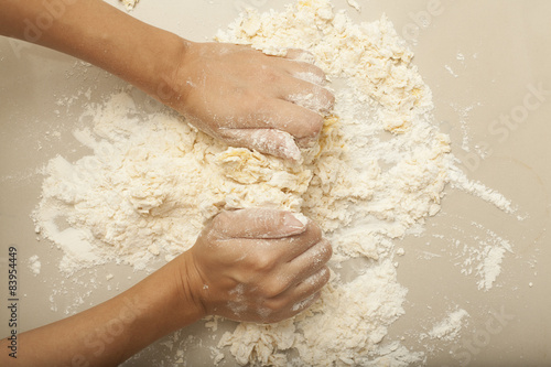 a female hand rolling threshing flour making pasta homemade