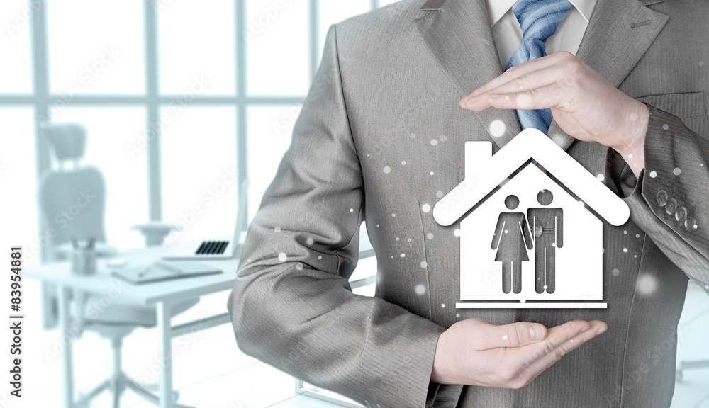 businessman protecting family in home with hands businessman protecting family in home with hands