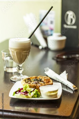 Canvas Print French cuisine: the Quiche pie served with sauce and greens