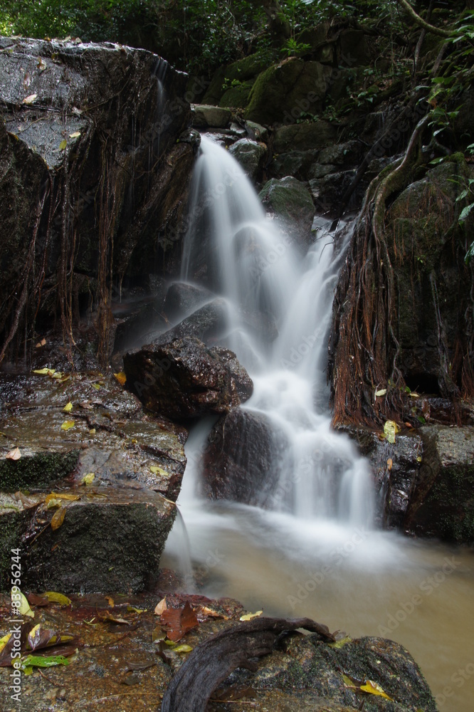 Obraz premium The small waterfall and rocks in forest, thailand