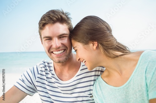 happy couple smiling together in front of the sea 