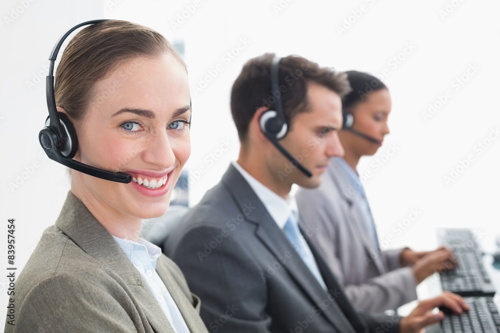 Business people with headsets using computers Business people with headsets using computers