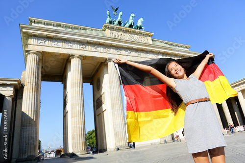 German flag woman joy at Berlin Brandenburger Tor photo