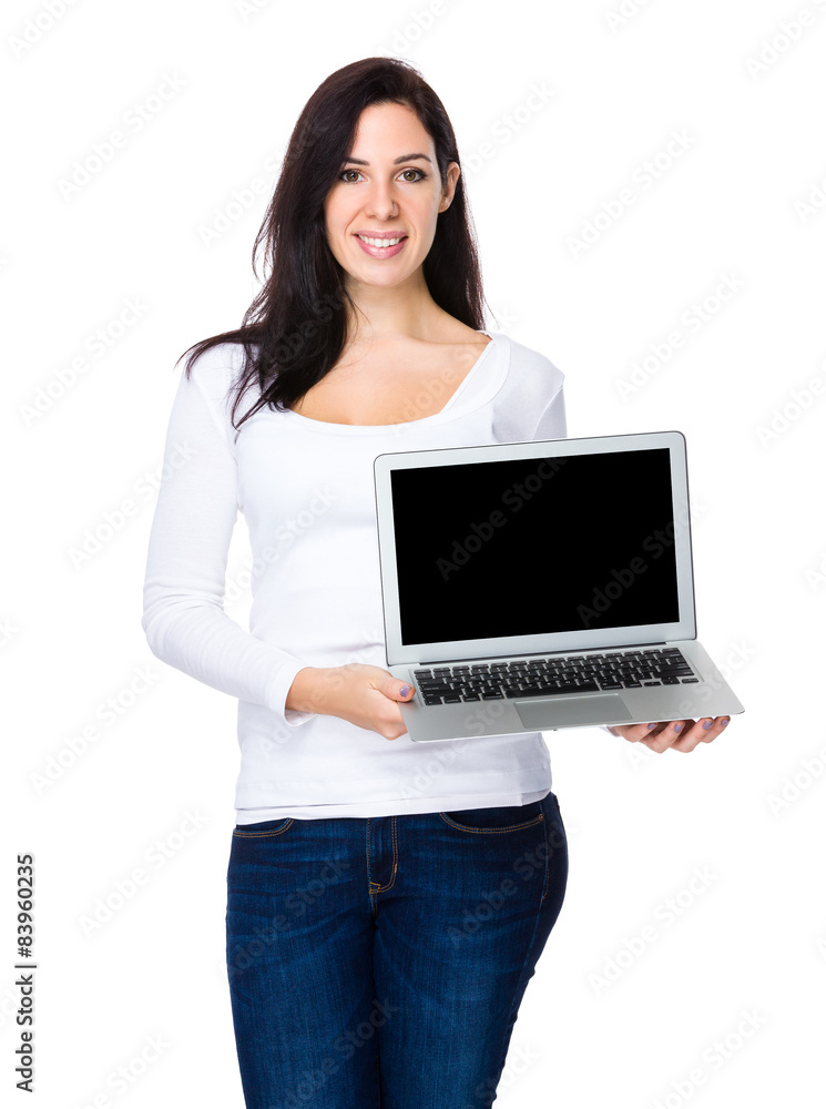 Brunette woman show with blank screen of laptop computer Brunette woman show with blank screen of laptop computer