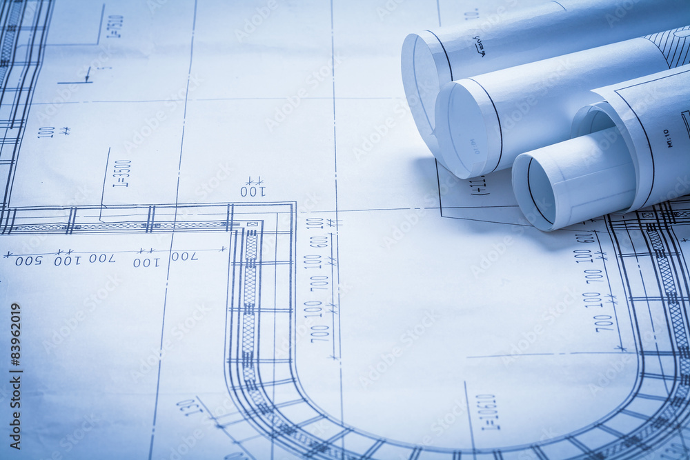 Rolled up blueprint rolls construction concept Rolled up blueprint rolls construction concept