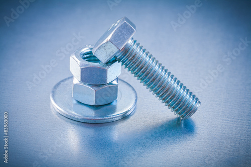 Threaded screwbolt nuts and bolt washer on metallic background c photo