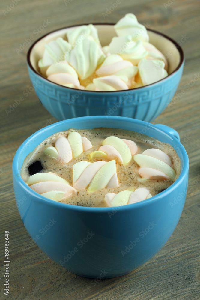 A cup of hot chocolate with marshmallows on the wooden background A cup of hot chocolate with marshmallows on the wooden background