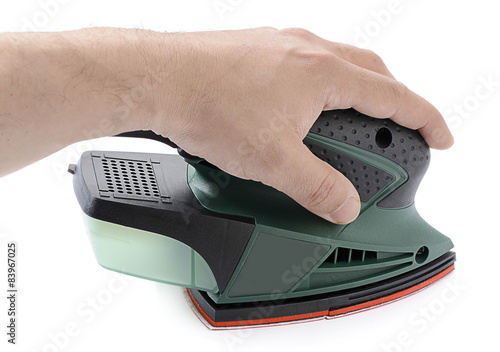 Obraz na plátně Left handed carpenter's hand sanding with electrical sander