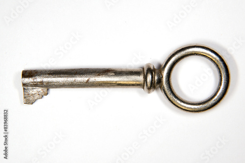 One old key to the safe on a white background © zheltobriukh
