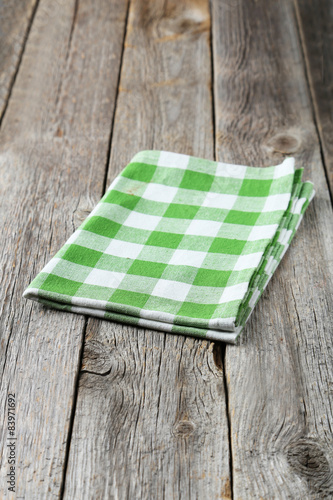 Green napkin on grey wooden background