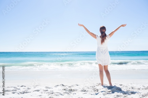 Pretty brunette standing arms outstretched 