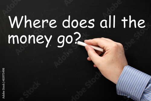 Writing Where Does All the Money Go? on a blackboard