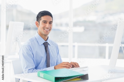 Smiling businessman using computer  photo