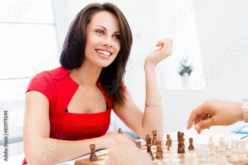 Business woman sitting in front of chess