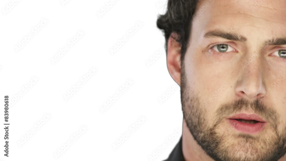 Man with a beard looks sad into the camera on a white background