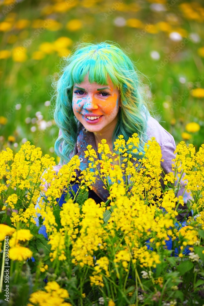 Beautiful hipster girl sits in grass with dandelion in park Beautiful hipster girl sits in grass with dandelion in park