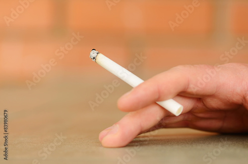 Male hand holding a cigarette