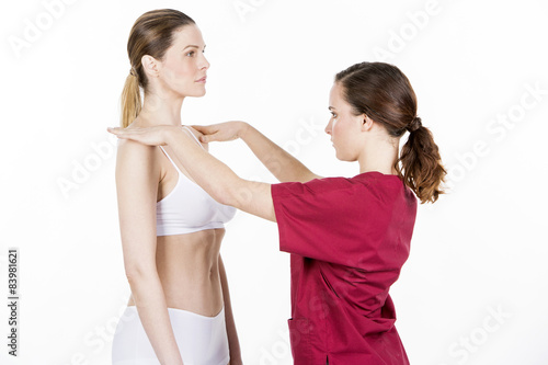 physiotherapist doing a physical examination of a woman