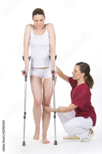 woman with crutch at the physiotherapist 