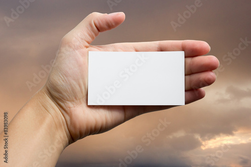 Hands holding a white business visit card, gift, ticket, pass, p