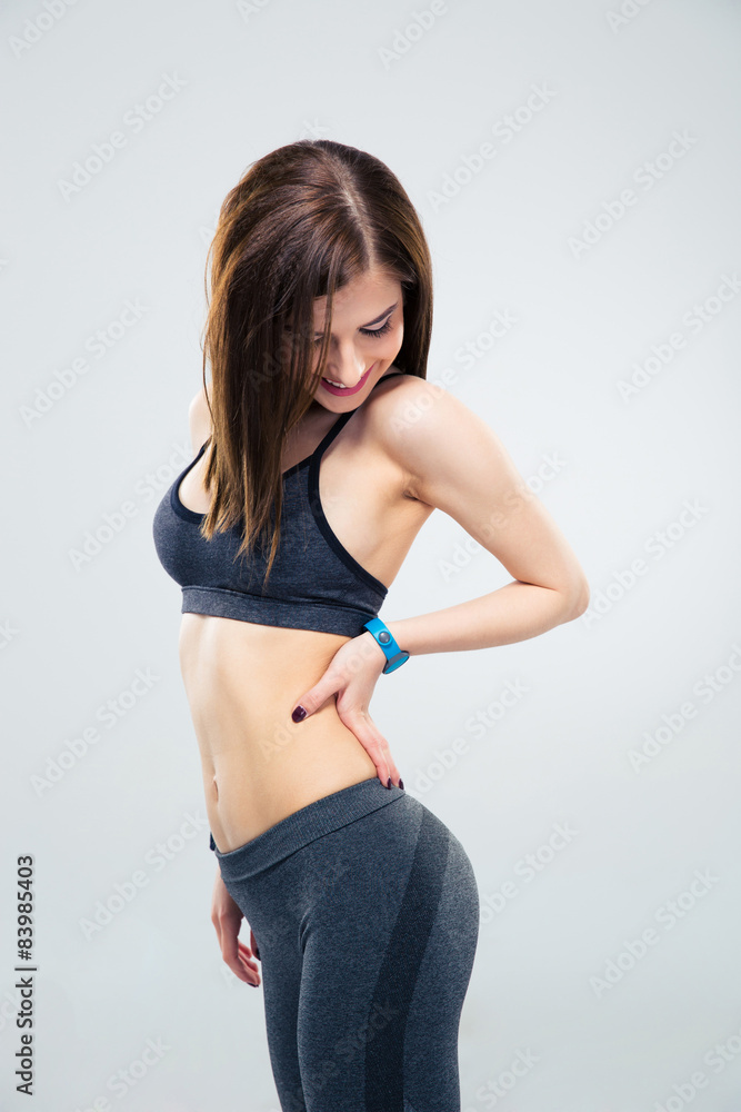Smiling cheerful woman posing over gray background Smiling cheerful woman posing over gray background