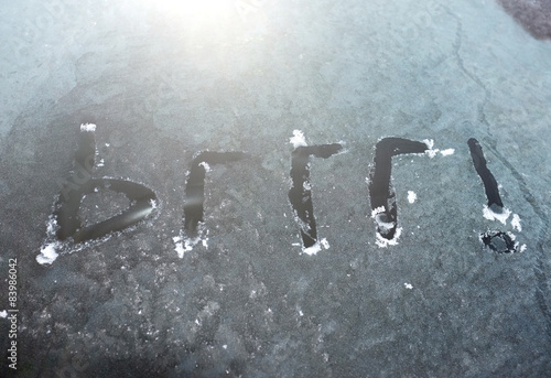 фотографія brrr! written in frost ice on a car windscreen