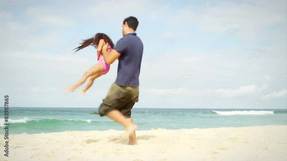 Father plays with his daughter on a beach in Brazil Father plays with his daughter on a beach in Brazil