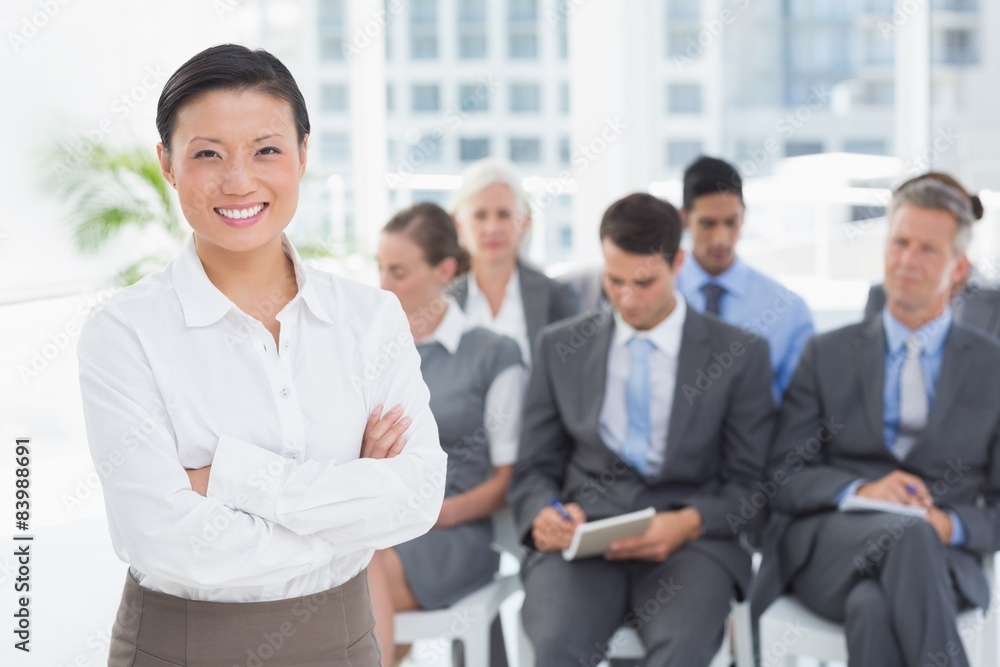 Business people looking at camera with arms crossed Business people looking at camera with arms crossed