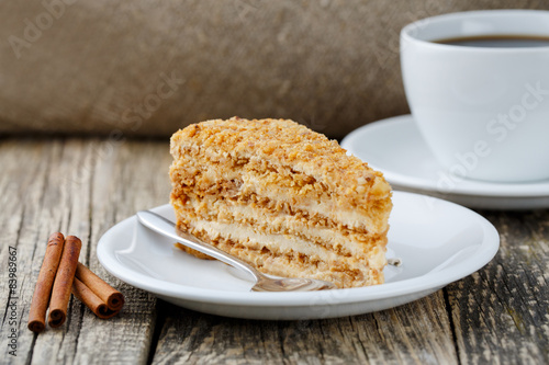 Tasty honey cake on wooden background.